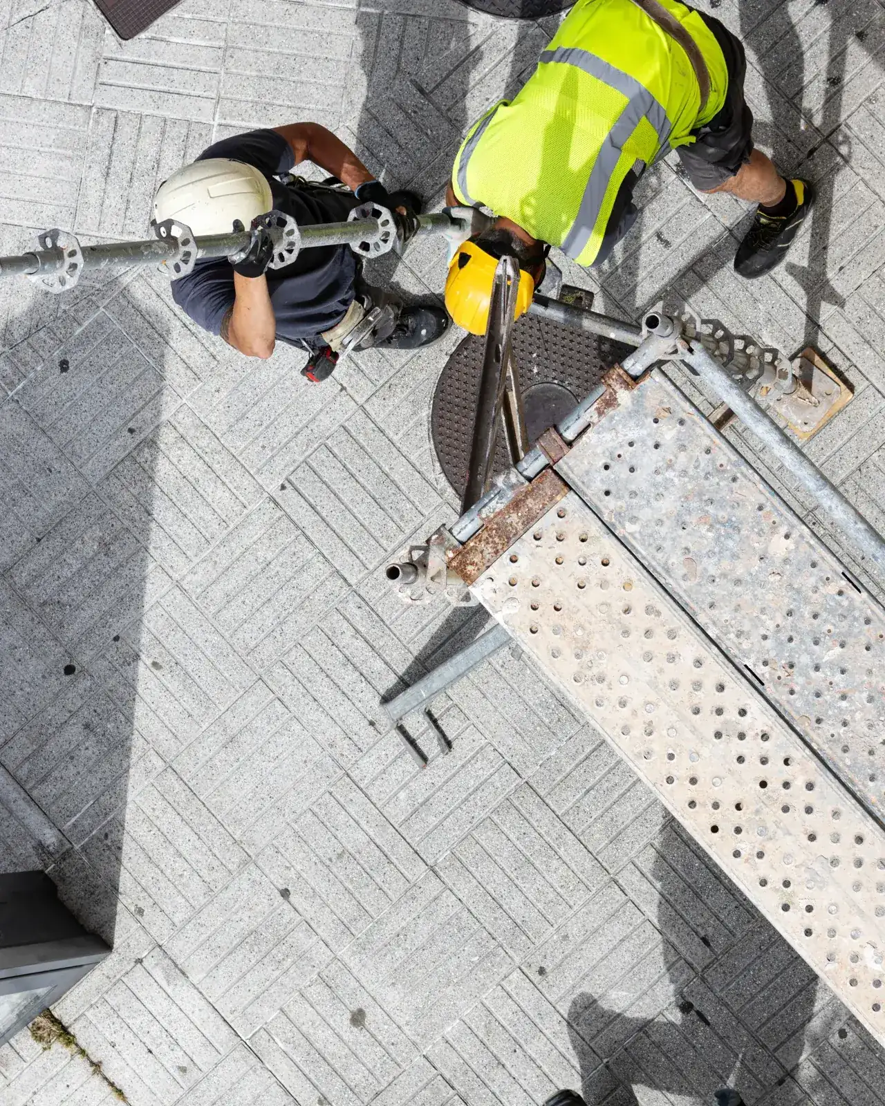 Overhead view of a worker in hi-vis at a scaffold